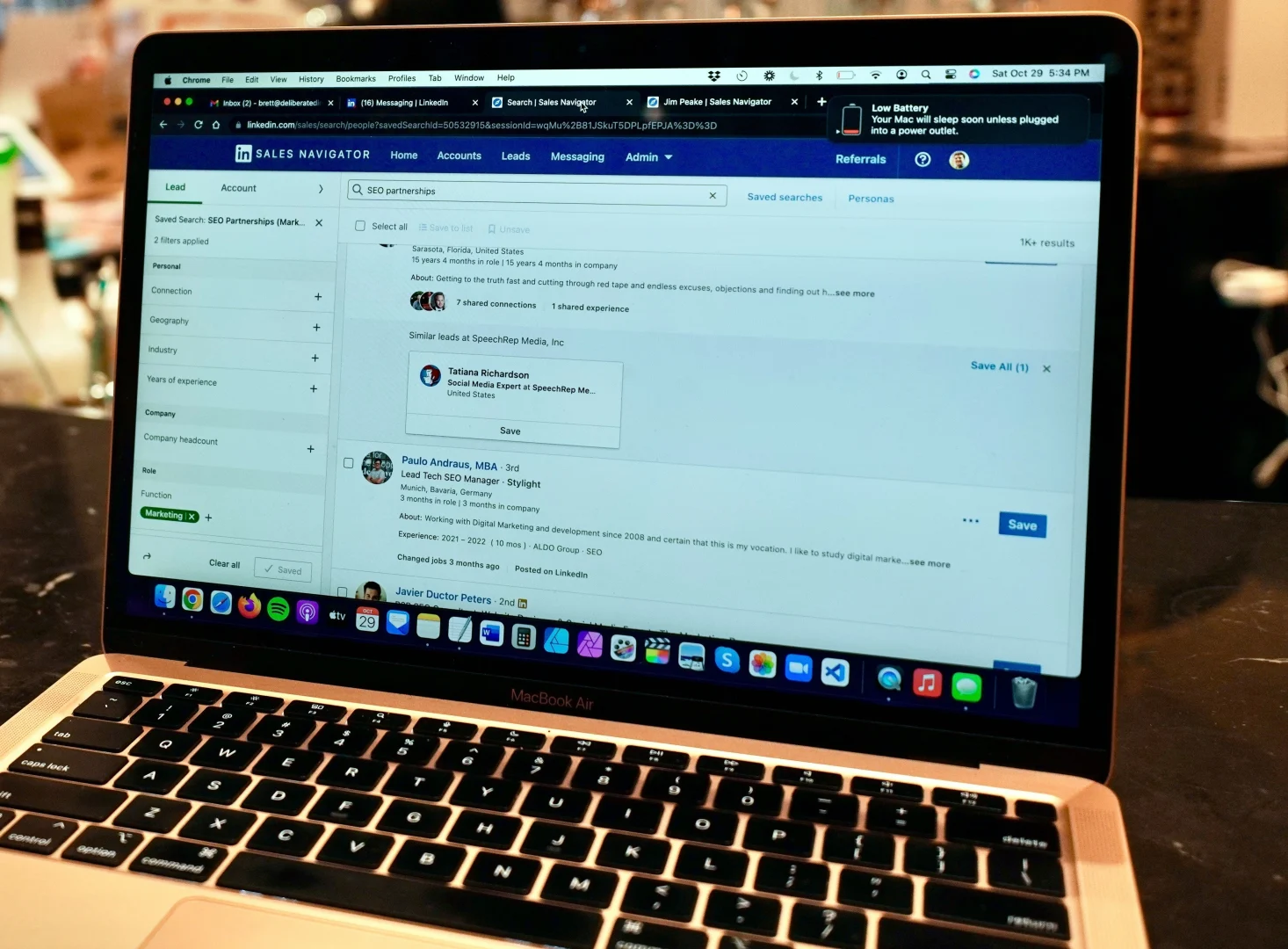 Laptop screen with LinkedIn Sales Navigator open, used for B2B recruiting and professional contact search.
