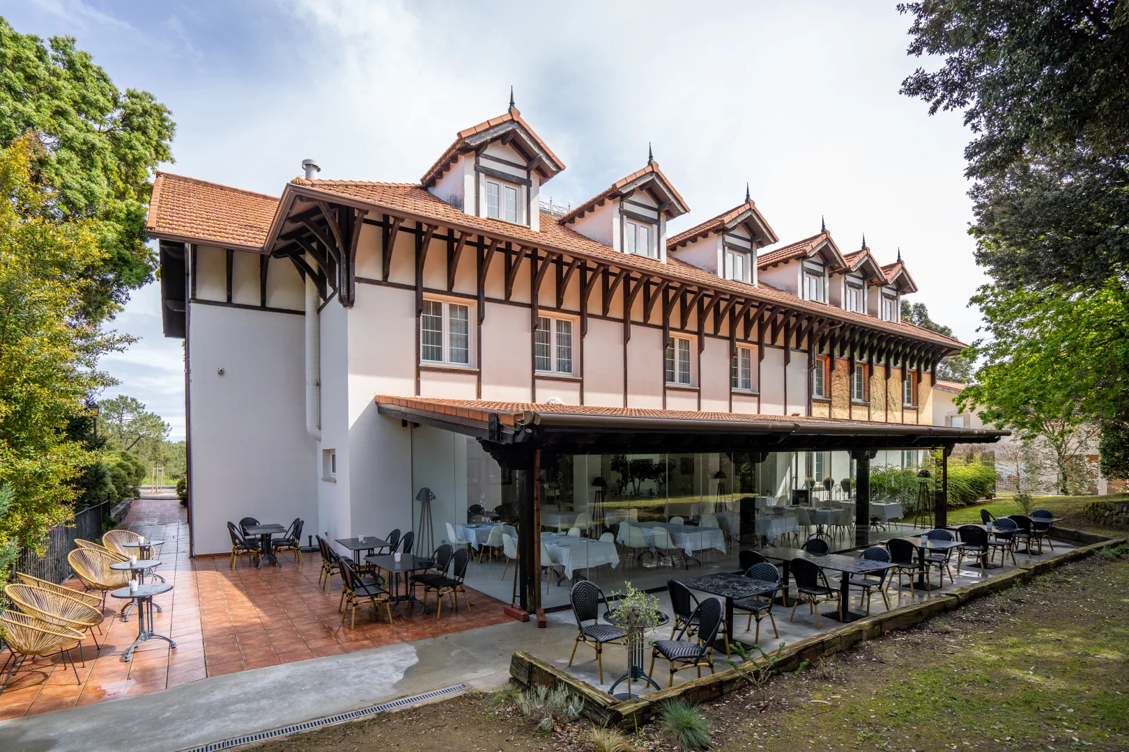 Charming hotel facade and outdoor terrace prepared for catering service.